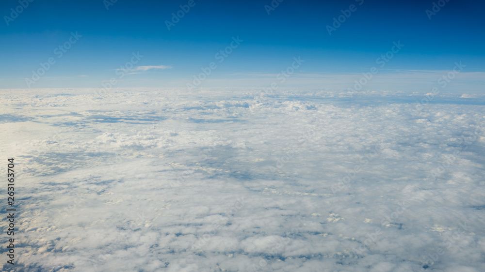 The beautiful cloudscape with clear blue sky. A view from airplane window. The beautiful cloudscape with clear blue sky. A view from airplane window.