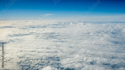 The beautiful cloudscape with clear blue sky. A view from airplane window. © REC Stock Footage