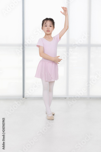 Pink dressed Asian girl in a ballet pose..