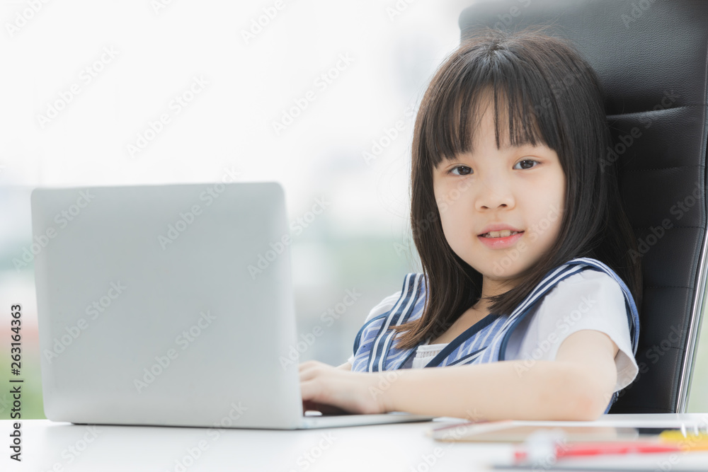 Asian girl uses laptop and smile to camera.. Asian girl uses laptop and smile to camera..