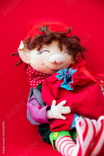 toy rag doll on red background. Art soft focus