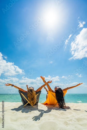 Woman enjoying her holidays on a transat at the tropical beach