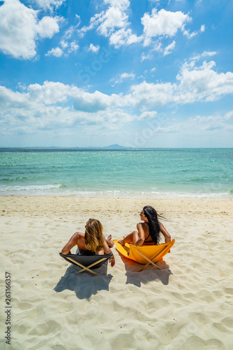 Woman enjoying her holidays on a transat at the tropical beach