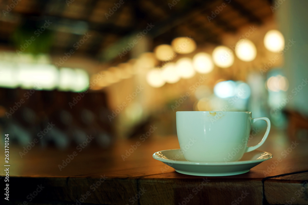 Coffee Cup on the Table in Cafe. Blurred Lights in bar as background Coffee Cup on the Table in Cafe. Blurred Lights in bar as background