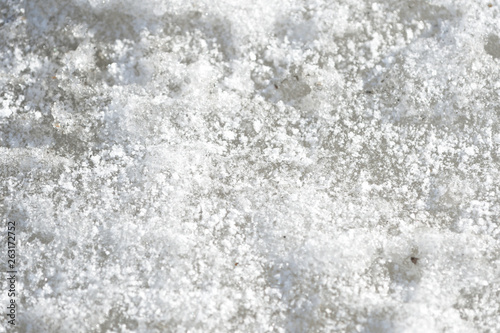 Abstract snow texture. Early spring snow background close up