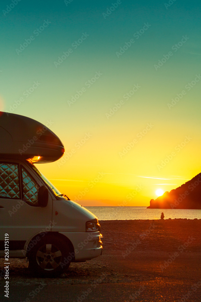 Camper car on nature at sunrise. Travel