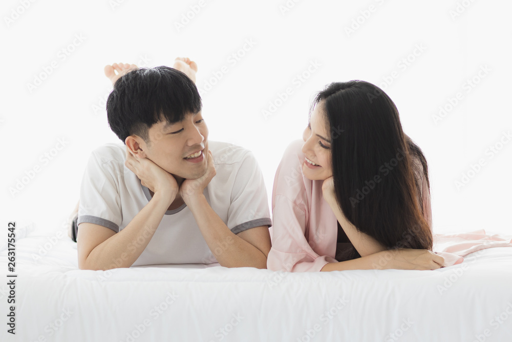 Asian couple spending time together on the bed. Asian couple spending time together on the bed.