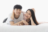 Asian couple spending time together on the bed..