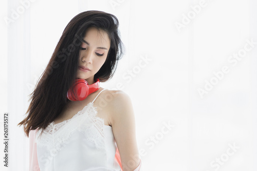 Asian black hair woman wearing red headphone..