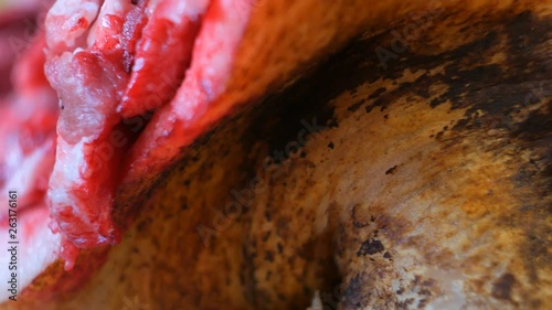 Bizarre pig head Circling on a table. Close-up. Pig heads being sold at the market.