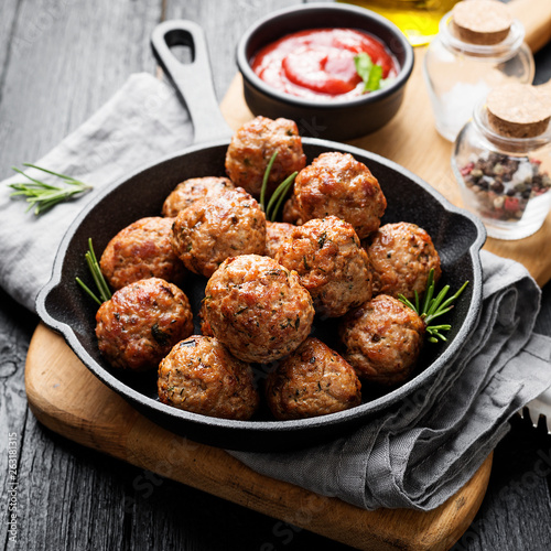 Obraz na plátně Meatballs served with tomato sauce in frying pan .