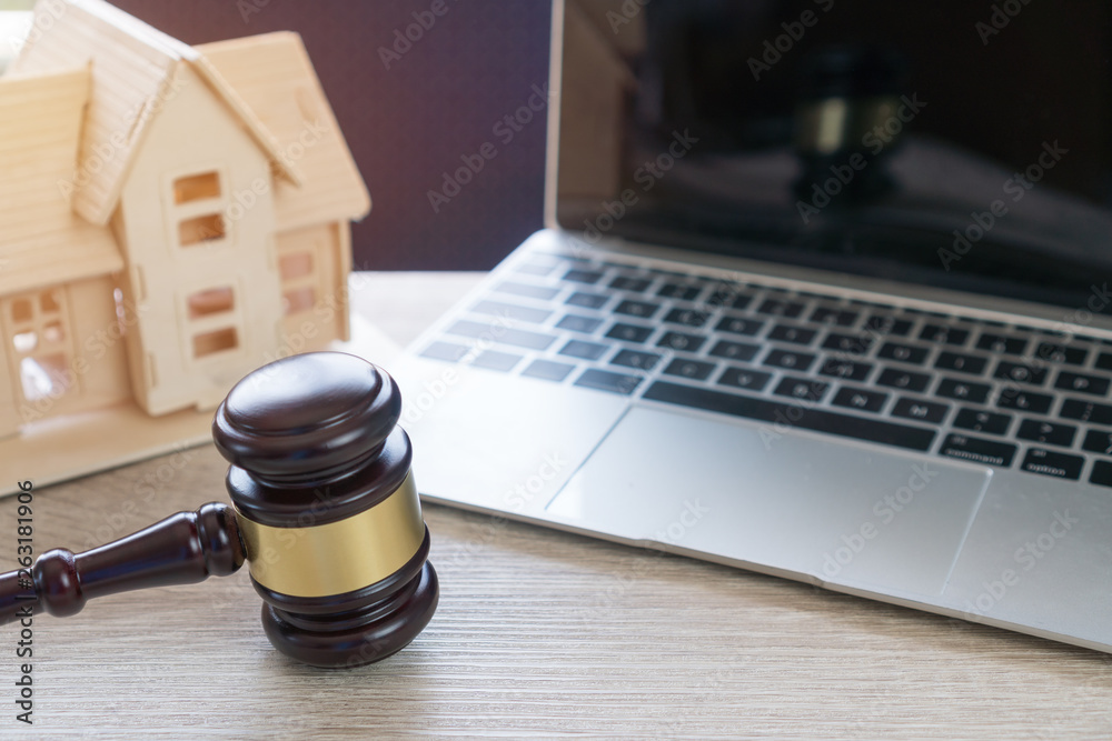 Lawyer business real estate property agent, home loan or divorce. Concept of Conflict lawsuit from not paying home debt, therefore requiring judgment prosecution. Judge hammer with house on Computer Lawyer business real estate property agent, home loan or divorce. Concept of Conflict lawsuit from not paying home debt, therefore requiring judgment prosecution. Judge hammer with house on Computer