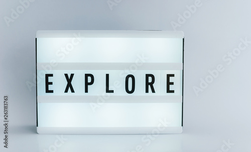 Photo of a light box, with text, EXPLORE, over white isolated background