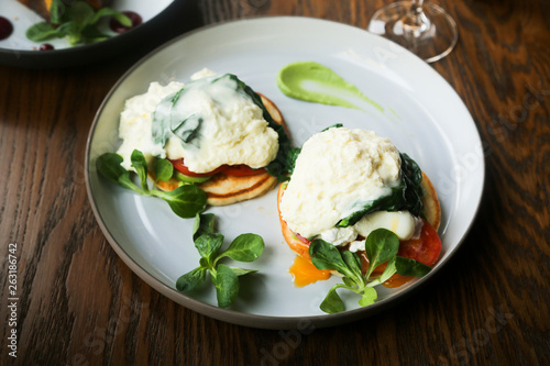 Pancakes with poached egg, cheese and spinach