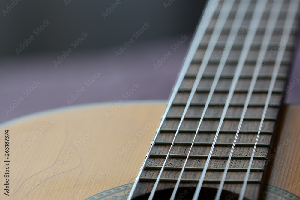 Fototapeta premium Old acoustic guitar with cracks on the soundboard close up