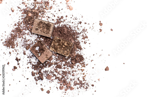 Deep brown crumbled eye shadow isolated on white background.