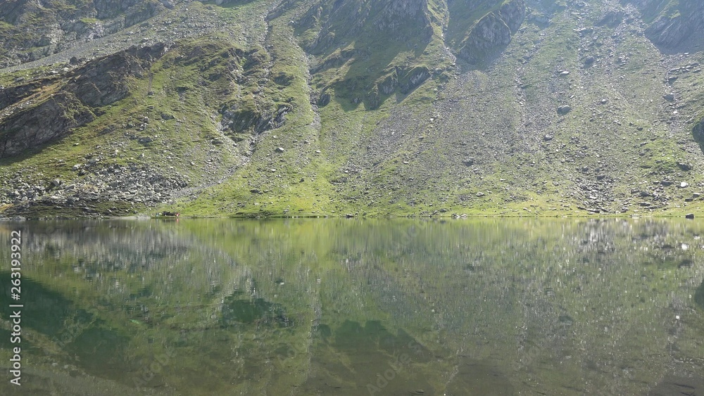 Beautiful tranquil lake in heart of mountains, Balea glacial lake, Transylvania Beautiful tranquil lake in heart of mountains, Balea glacial lake, Transylvania