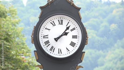 Needles motion of big clock in the mountain town photo