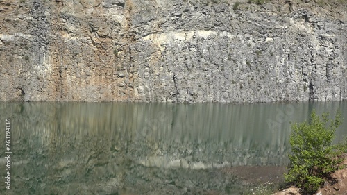 Basalt wall reflected into volcanic lake