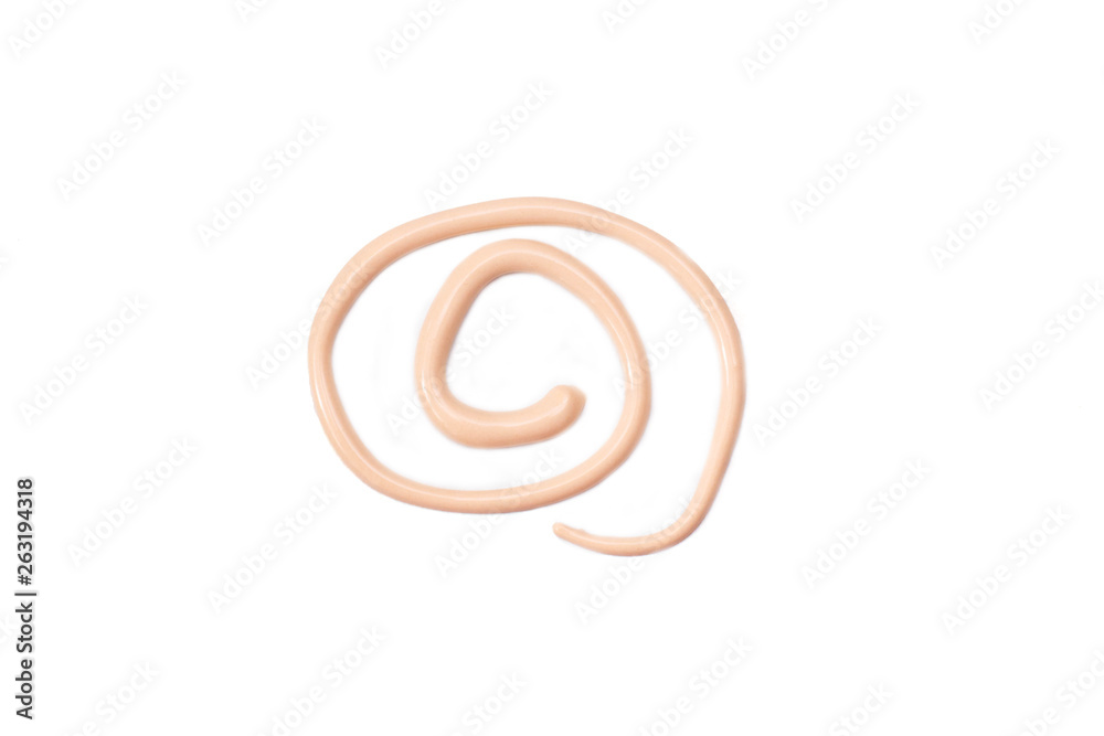 Foundation smeared in the form of a spiral, on a white background - isolate Foundation smeared in the form of a spiral, on a white background - isolate