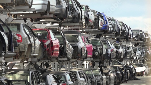 Broken cars in junkyard photo