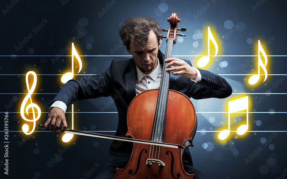 Fototapeta premium Young handsome cellist playing with music sheet background