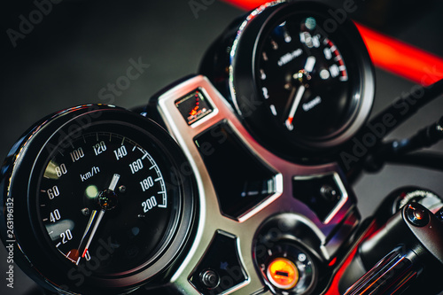 Close up detail shot of dashboard display of speedometer & analog gauge of modern sport motorcycle.