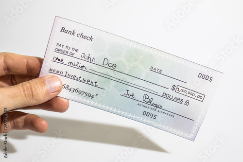 Holding a million dollar bank check isolated in a white background