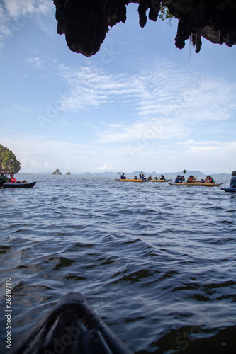 Couple canoeing or kayaking at sea island backdrop. Krabi province, Thailand. Space for text photo