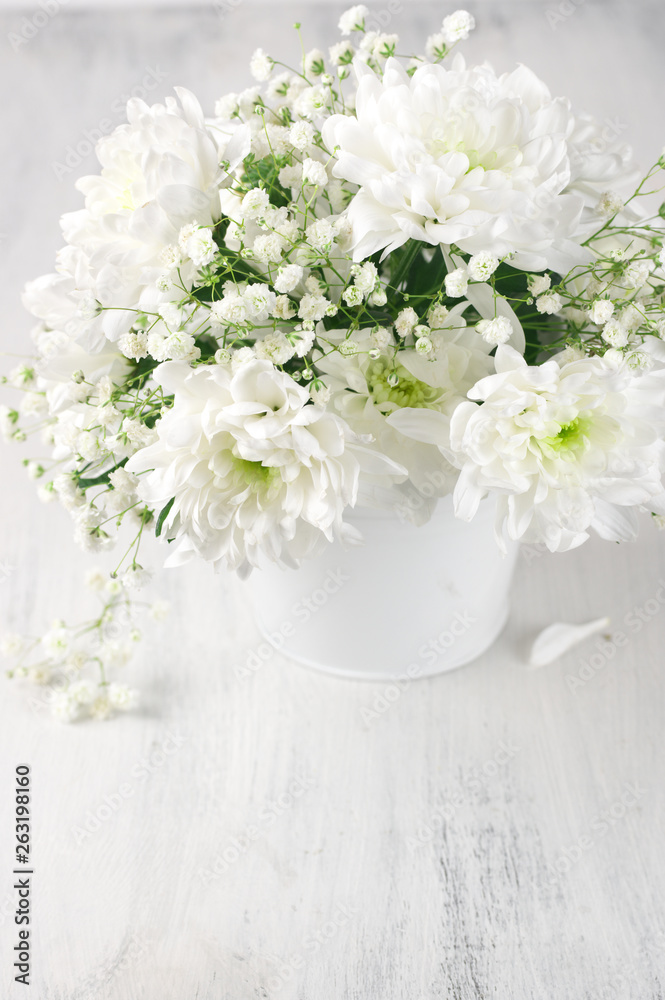 White flowers bouquet in bucket