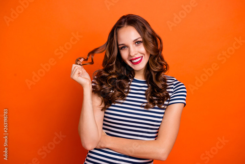 Close up photo beautiful amazing she her lady glossy red lipstick hold play arm curls overjoyed easy-going wear casual striped white blue t-shirt clothes isolated orange bright background