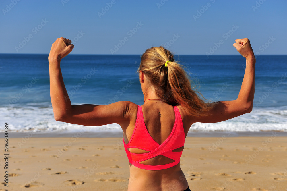 Strong woman with hands in air