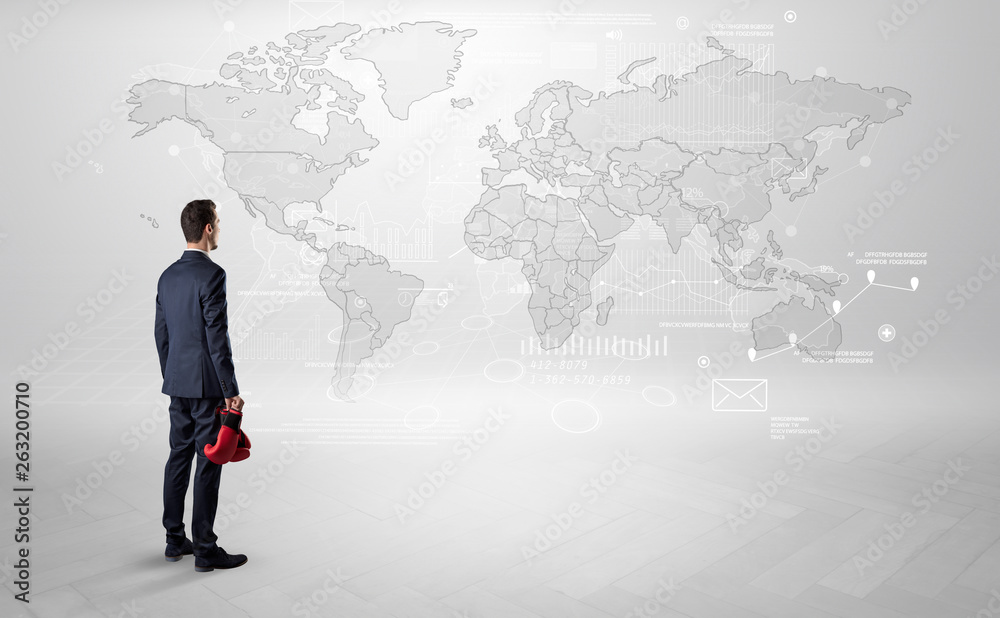 Businessman standing with his back and looking at a worldwide map with objects in his hand
Businessman standing with his back and looking at a worldwide map with objects in his hand