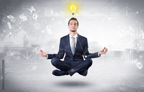 Businessman meditates with enlightenment data reports and financial concept 
