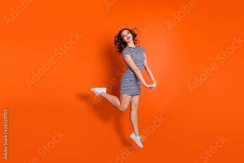 Full length size body photo of charming with toothy beaming teeth smile hipster student she her lady having walk go raising one leg up isolated vivid background