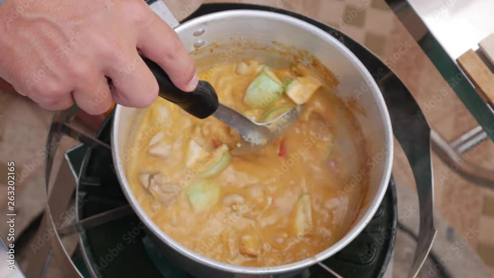 Step by step cooking tom yam soup. Spicy chili peppers and herbs are added to boiling soup. Thai cuisine. Closeup. 4k Step by step cooking tom yam soup. Spicy chili peppers and herbs are added to boiling soup. Thai cuisine. Closeup. 4k