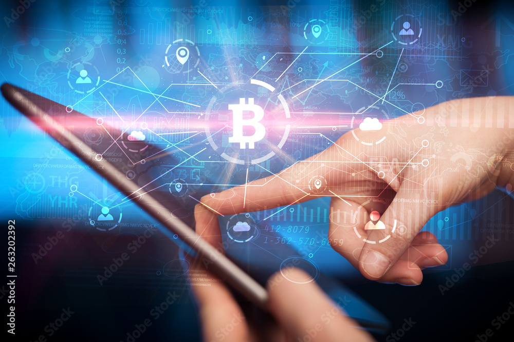 Hand using tablet with cryptocurrency bitcoin link network and online concept
