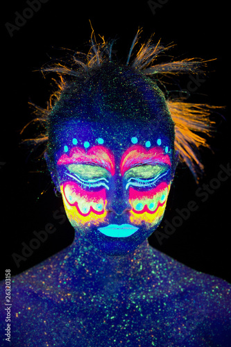Blue woman portrait, aliens sleeps, ultraviolet make-up.  Beautiful on a dark background. Full face portrait, eyes closed