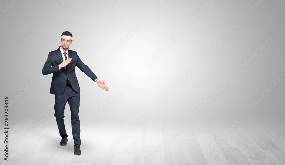 Young businessman in suit fighting in an empty space
Young businessman in suit fighting in an empty space