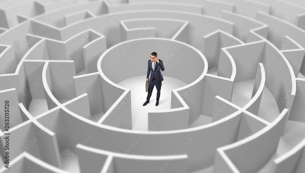Young businessman standing in a middle of a 3d round maze
Young businessman standing in a middle of a 3d round maze
