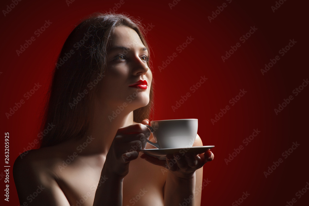 custom made wallpaper toronto digitalAttractive lady brunette with pleasure holding a coffee cup in hand in studio at the red background