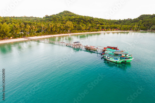 Sea wooden pier with boat on beach