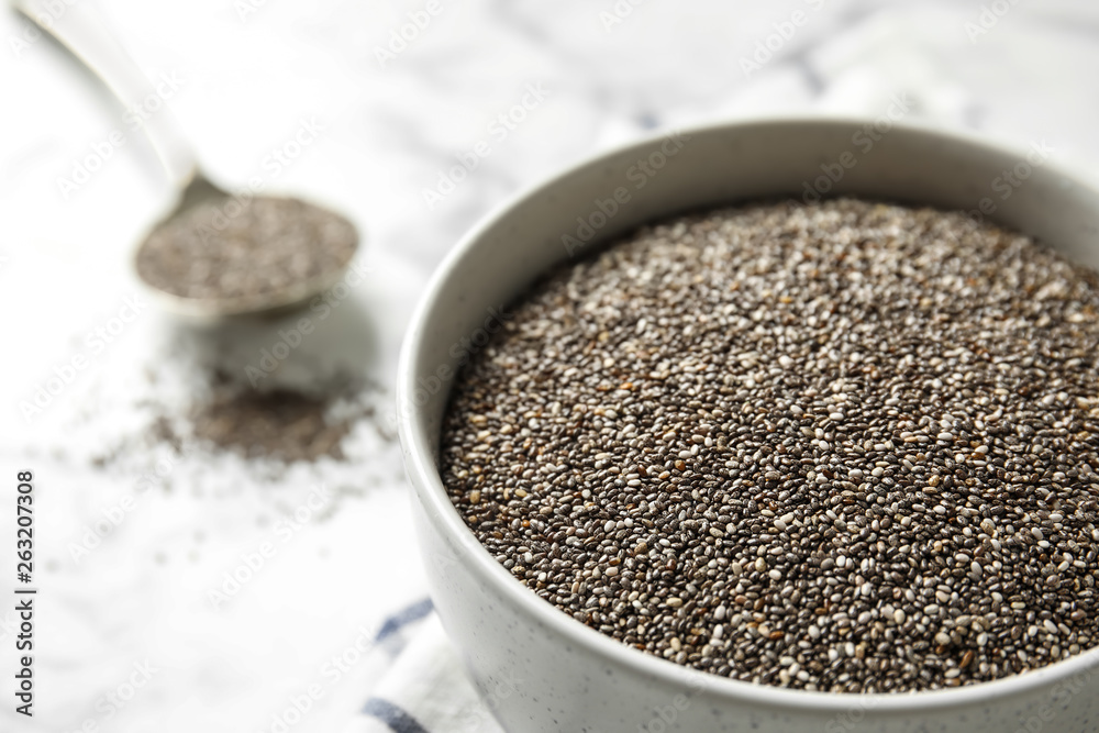Bowl with chia seeds on table, closeup. Space for text Bowl with chia seeds on table, closeup. Space for text