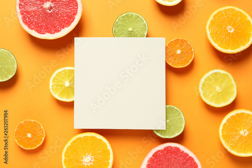 Fototapeta Naklejka Na Ścianę i Meble -  Fresh citrus fruits and blank card on color background, flat lay. Space for text