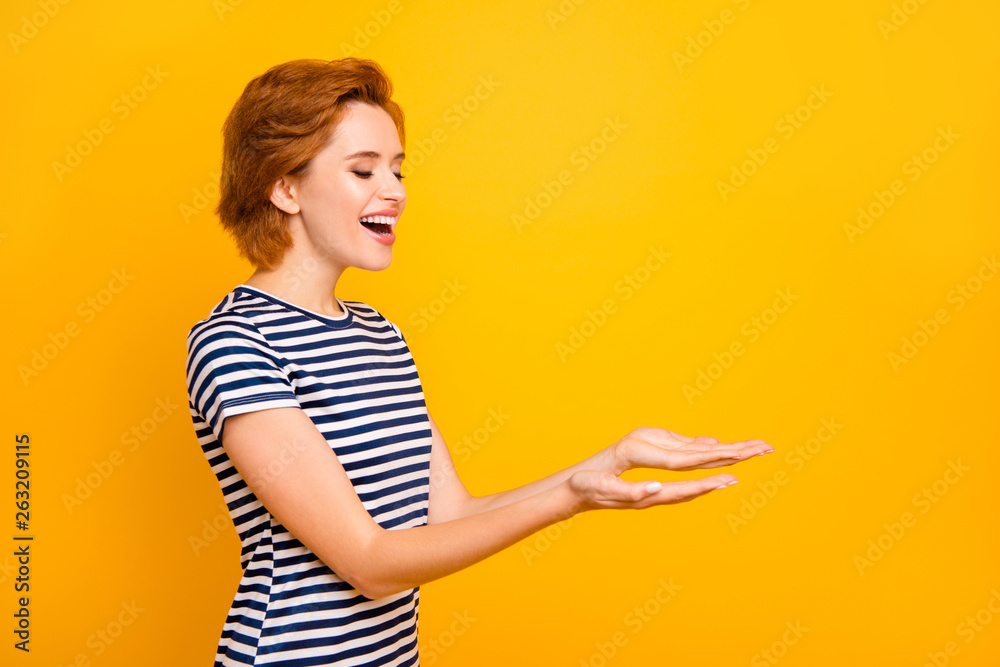 Close up side profile photo beautiful she her lady hands arms palms empty space showing new product excited wear casual striped white t-shirt outfit clothes isolated yellow bright background Close up side profile photo beautiful she her lady hands arms palms empty space showing new product excited wear casual striped white t-shirt outfit clothes isolated yellow bright background