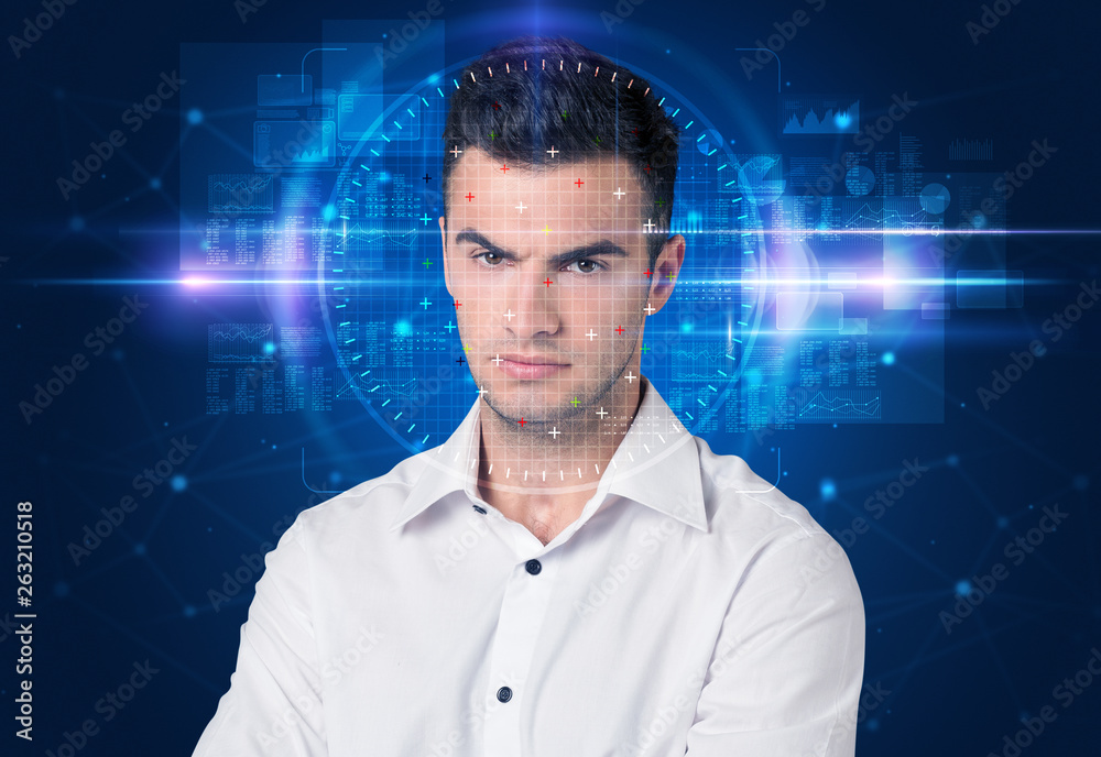 Facial recognition system. Young man on blue background Facial recognition system. Young man on blue background