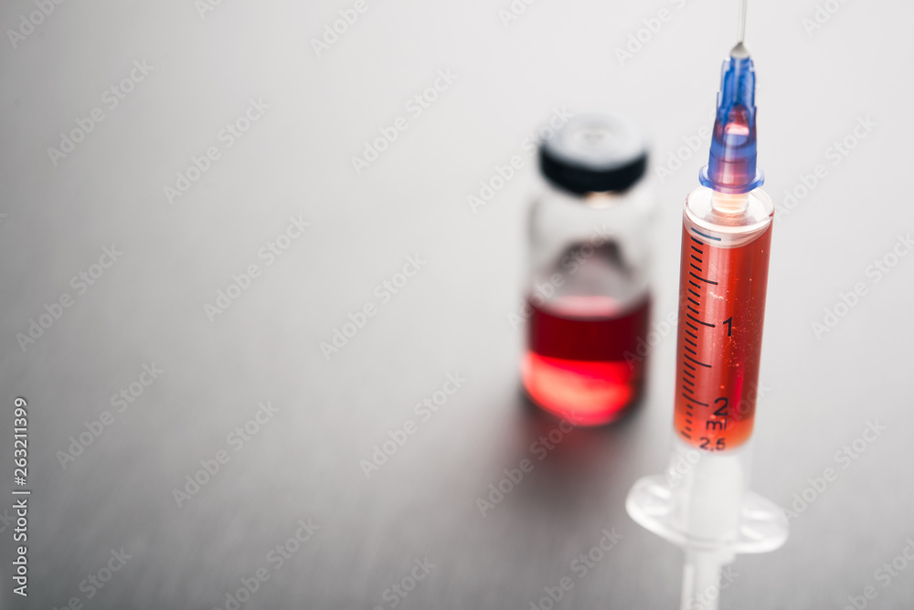 ampule with red medicine and syringe ampule with red medicine and syringe