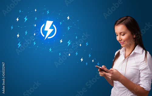 Young person using phone with power concept
 photo