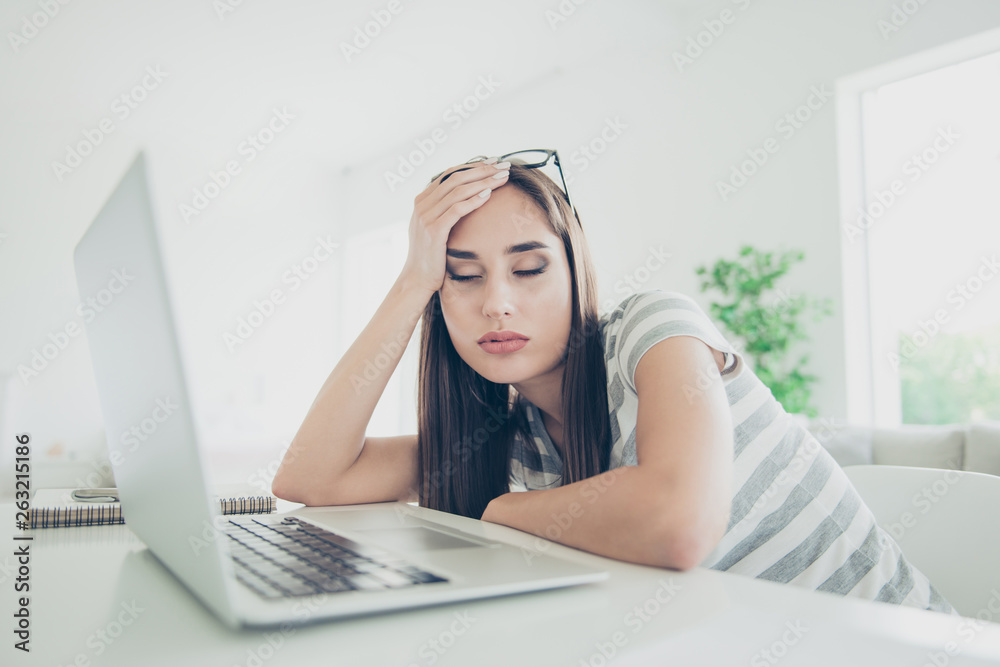 Obraz premium Close up photo beautiful she her lady notebook table sleepy eyes closed head lean arm hand sleepless night wait skype call wear jeans denim striped t-shirt sit comfort chair house living room indoors
