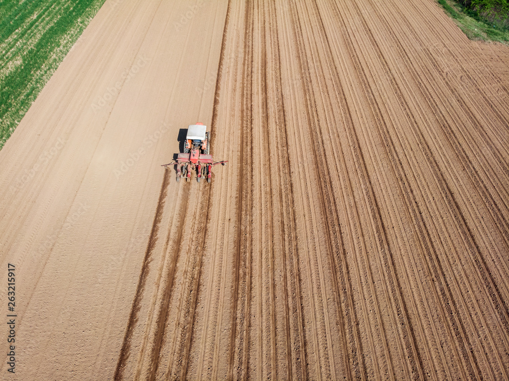 Aerial view of a tractor plowing the fields, aerial view, plowing, sowing, harvest. Agriculture and Farming, campaign. Desert and dehydrated lands, global warming Aerial view of a tractor plowing the fields, aerial view, plowing, sowing, harvest. Agriculture and Farming, campaign. Desert and dehydrated lands, global warming